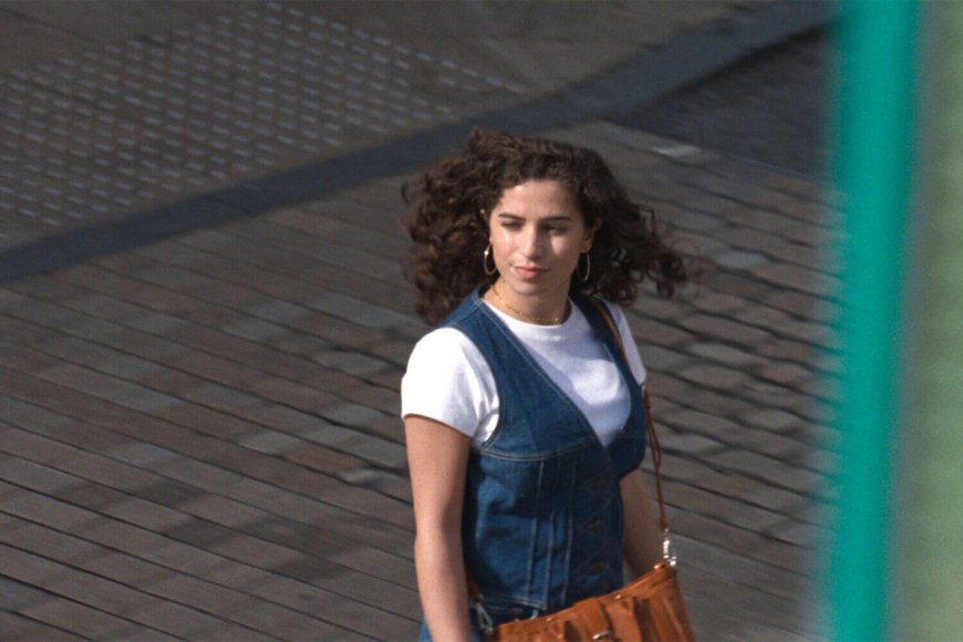 woman in a jeansdress crossing a street